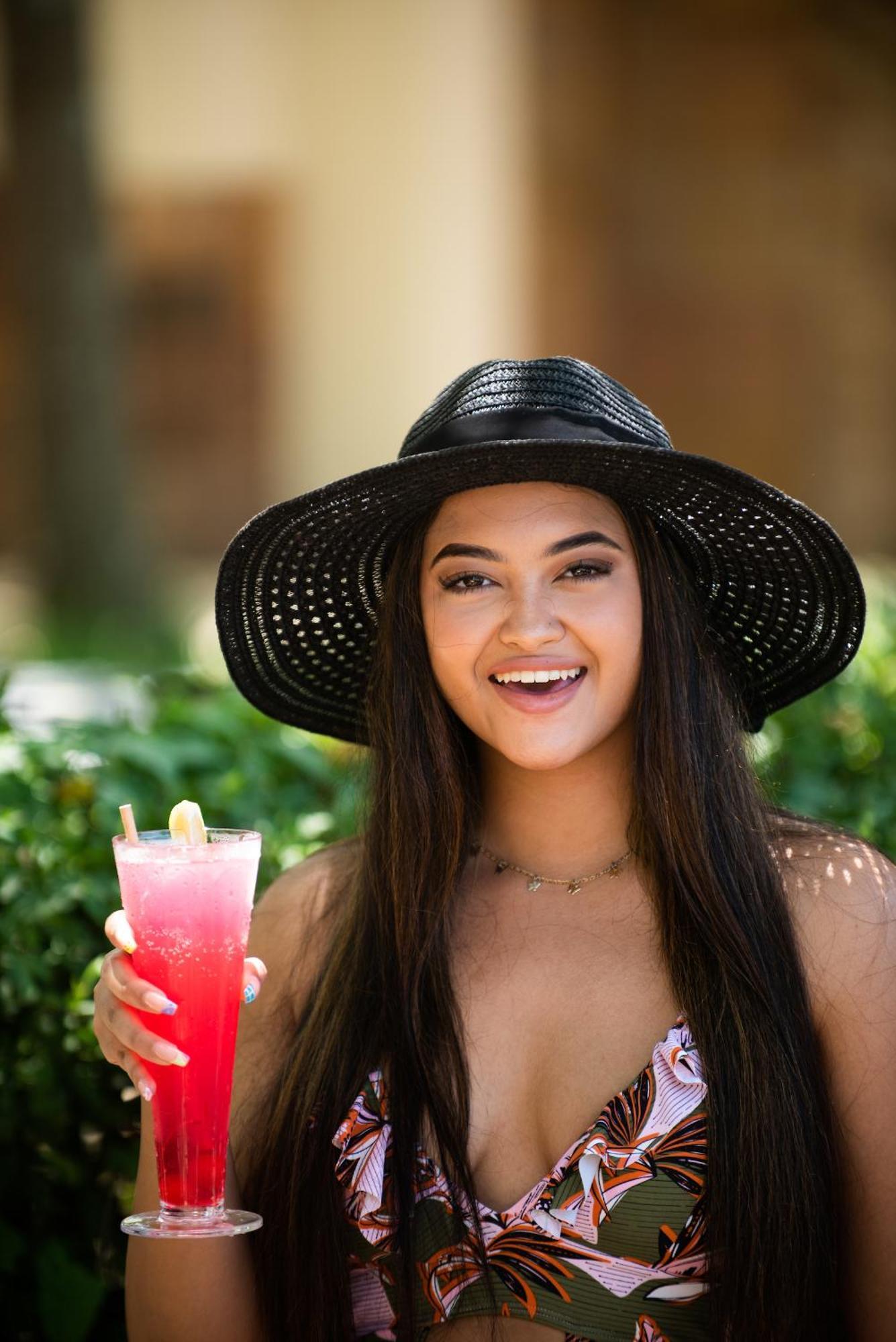 The Capital Zimbali Hotel Ballito Kültér fotó A woman wearing a sun hat