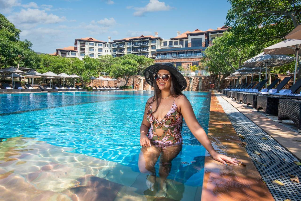 The Capital Zimbali Hotel Ballito Kültér fotó A woman wearing a sun hat