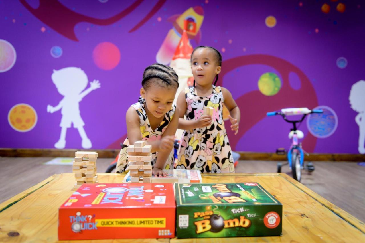 The Capital Zimbali Hotel Ballito Kültér fotó Two children playing with board games